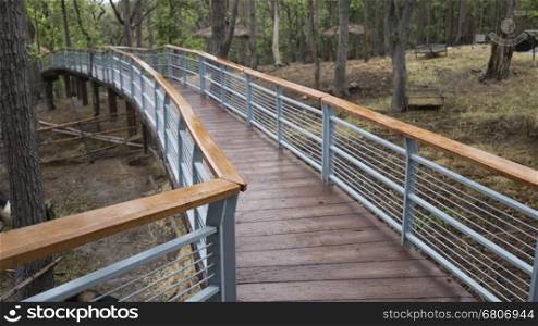 elevated pedestrian walkway in park in rainy day