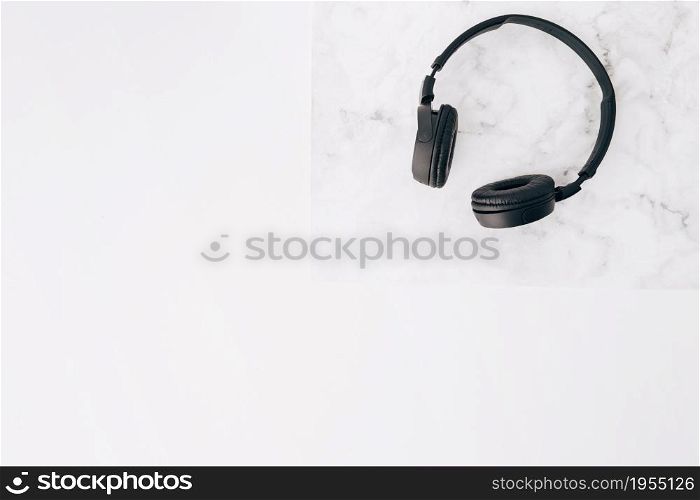 elevated view black headphone desk white background