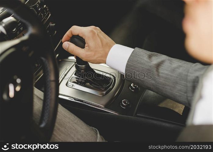 elevated view businessman driving car moving transmission shift gear