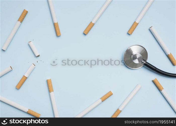 elevated view cigarette stethoscope blue background