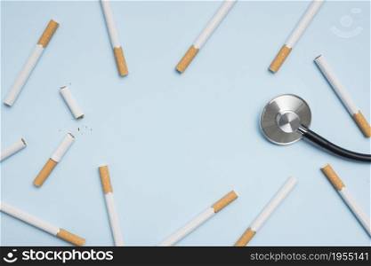 elevated view cigarette stethoscope blue background