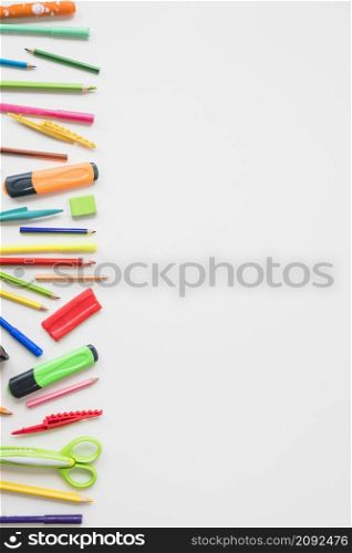 elevated view colorful school accessories white backdrop