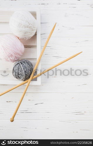 elevated view colorful yarns crochet wooden background