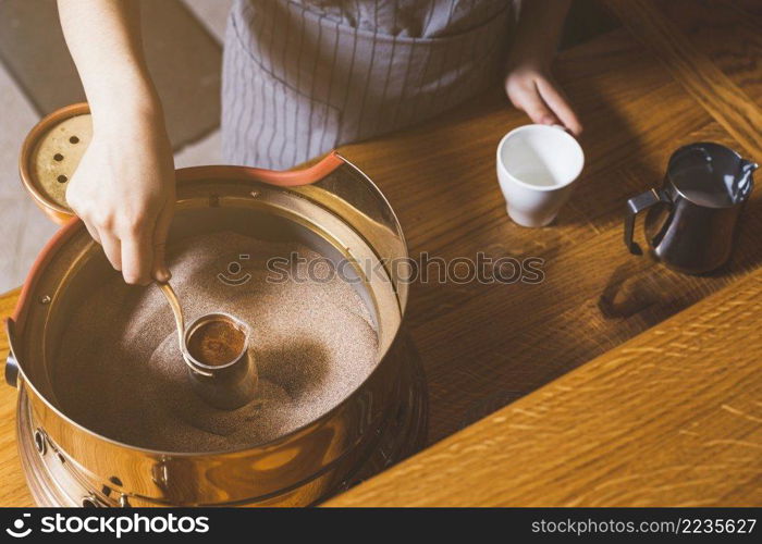 elevated view female hand making turkish coffee sand caf