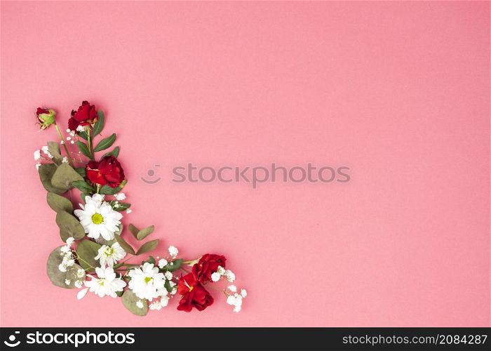 elevated view flowers leaf decorated peach background