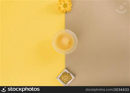 elevated view flowers lemon curd bee pollen dual colored background