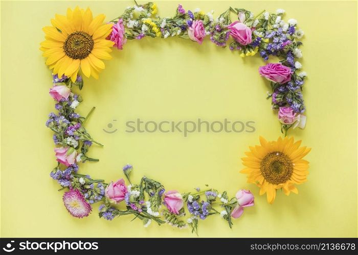 elevated view fresh flowers forming frame yellow surface