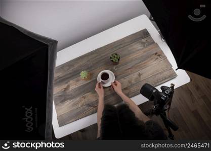 elevated view grapher arranging cup tea shooting studio