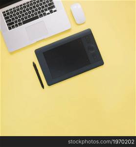 elevated view graphic digital tablet laptop yellow background. High resolution photo. elevated view graphic digital tablet laptop yellow background. High quality photo