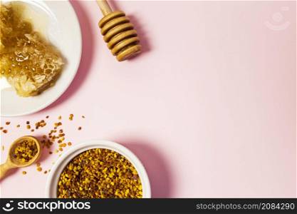 elevated view honeycomb bee pollen pink surface