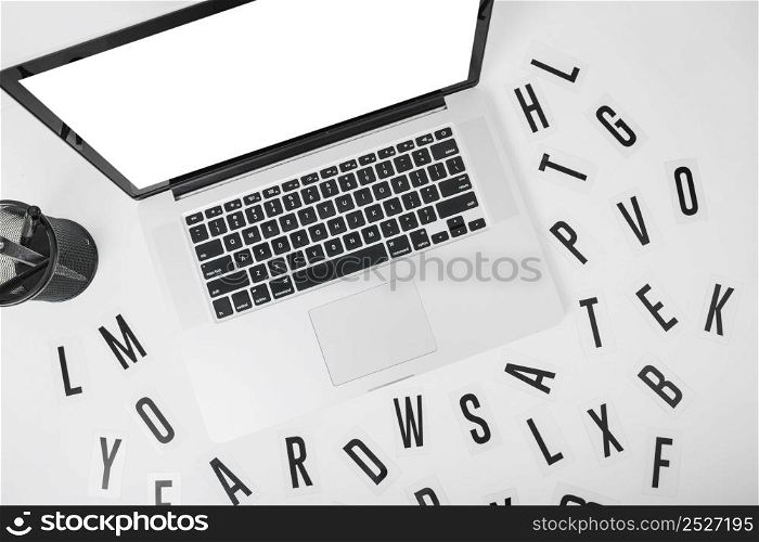 elevated view laptop with various alphabets white background
