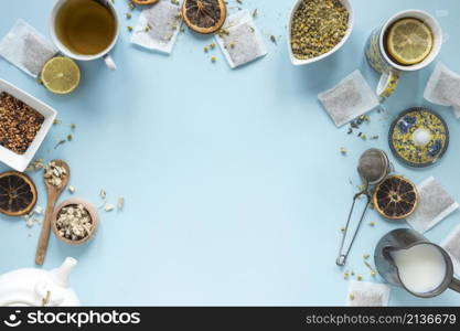 elevated view lemon tea herbs milk strainer dried chinese chrysanthemum flowers teapot teabags arranged blue background
