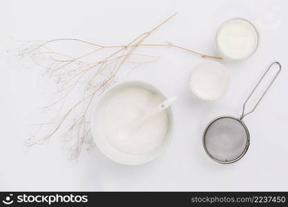 elevated view milk sugar kitchen utensil with twig