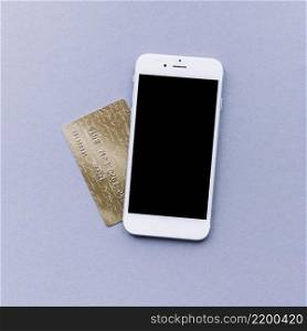 elevated view mobile phone credit card grey background