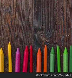 elevated view multicolored wax crayons brown plank