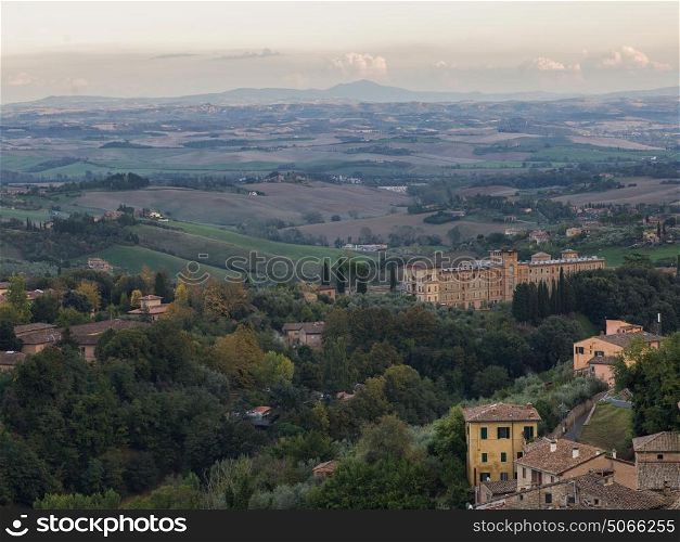 Elevated view of buildings with rural landscape in background, Siena, Tuscany, Italy