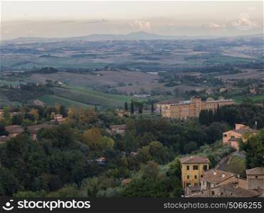 Elevated view of buildings with rural landscape in background, Siena, Tuscany, Italy