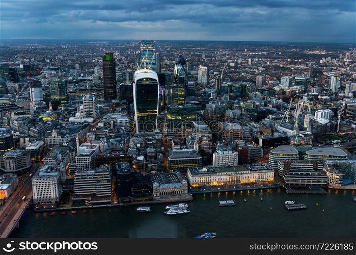 Elevated view of The City of London on a cloudy Spring night. Grained.