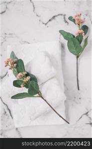 elevated view pink flowers white napkins marble surface