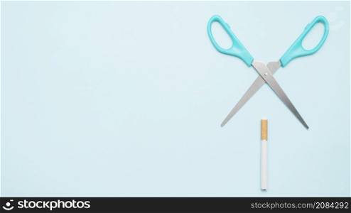 elevated view scissor with cigarette blue backdrop