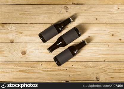 elevated view three beer bottles wooden background