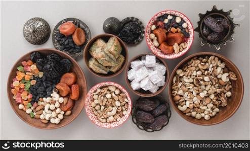 elevated view traditional sweets dried fruits nuts white background