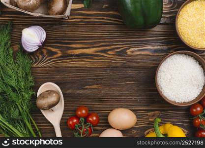 elevated view vegetables with bowl rice grains polenta wooden table