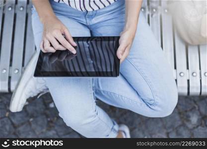 elevated view woman touching digital tablet screen