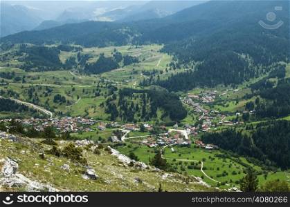 Elevational view of forest mountain village in sunny day