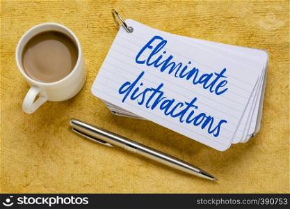 Eliminate distractions - handwriting on a stack of index cards with a cup of coffee and a pen against yellow textured paper