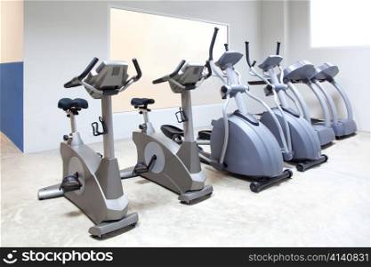 elliptical cross trainer, stationary bicycle and treadmill in gym