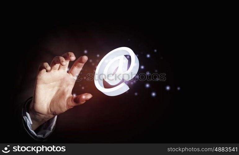 Email concept. Close up of businessman holding email icon in palm