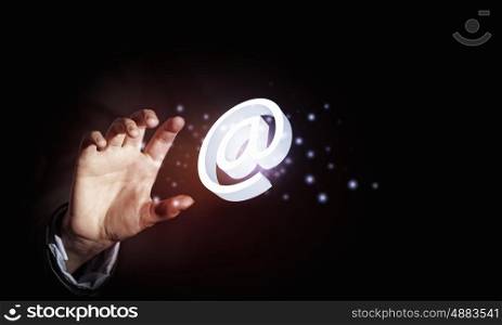 Email concept. Close up of businessman holding email icon in palm
