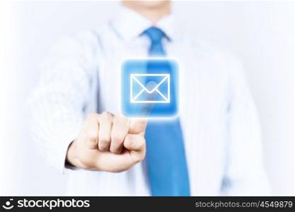 Email concept. Close up of businessman touching mail icon