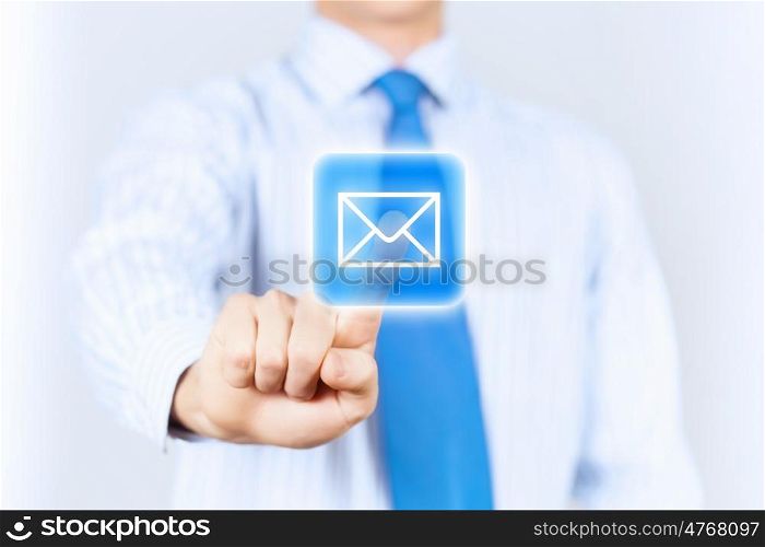 Email concept. Close up of businessman touching mail icon