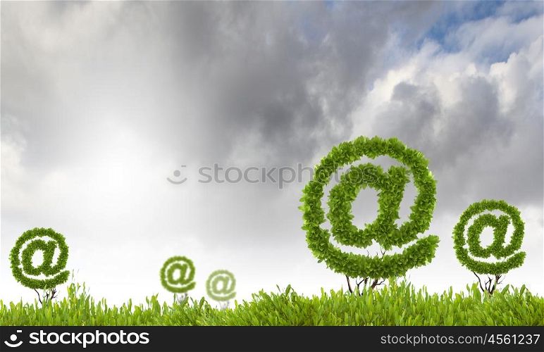 Email concept. Conceptual background image of plant in pot shaped like email sign