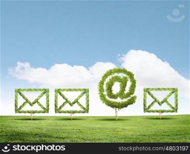 Email concept. Conceptual image of green plant shaped like email sign