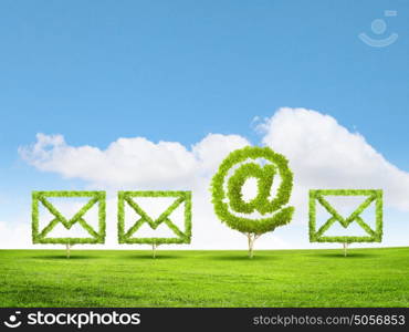 Email concept. Conceptual image of green plant shaped like email sign