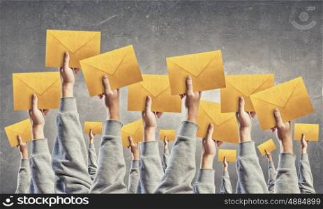 Email concept. Crowd of businesspeople lifting up hands with email signs