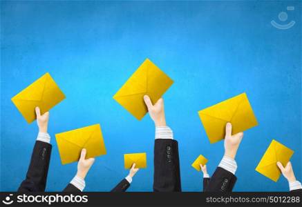 Email concept. Crowd of businesspeople lifting up hands with email signs