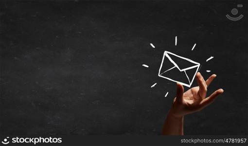 Email concept. Person hand taking chalk drawn email sign
