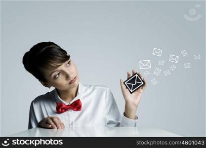 Email concept. Young woman holding icon with communication sign
