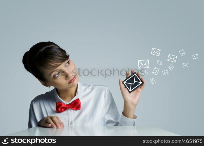 Email concept. Young woman holding icon with communication sign