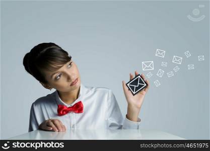 Email concept. Young woman holding icon with communication sign