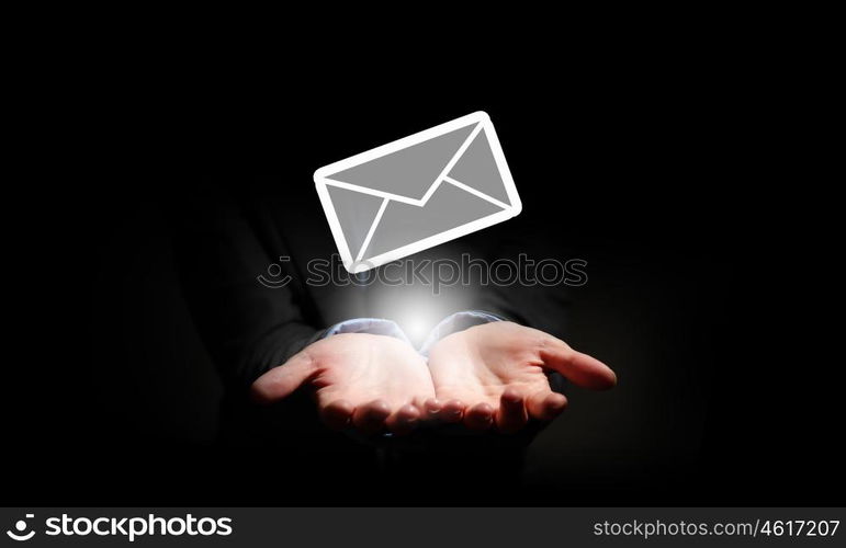 Email symbol. Close up of businessman hand holding email sign