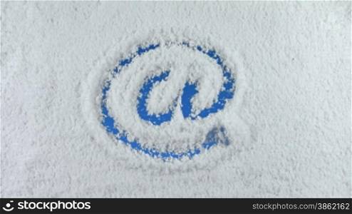 Email symbol drawn on snow background with matte