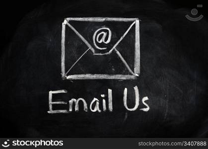 Email us concept with an internet symbol and envelope drawn with chalk on blackboard