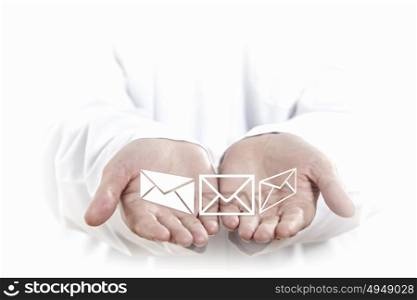 Emailing. Close up of human hands with mail white symbols