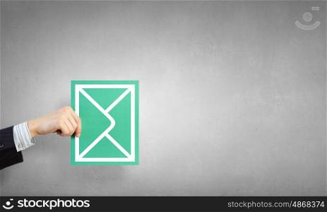 Emailing concept card. Hand holding envelope card representing email concept
