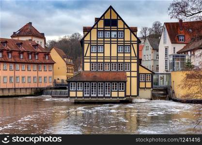 Embankment of the old city on a cloudy day. Bamberg. Bavaria Germany.. Bamberg. Old city embankment at sunset.
